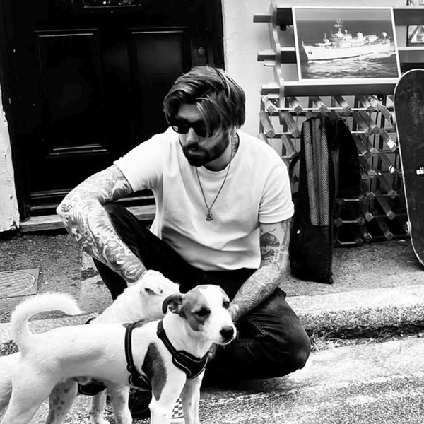 Mitchell Hughes, founder of StoryboardCanvas, with his dogs